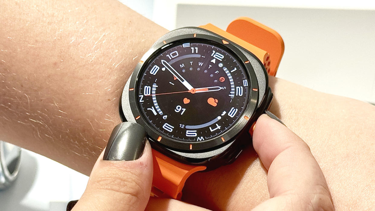  The Samsung Galaxy Watch Ultra on an orange rubber strap worn on the wrist of a user. 