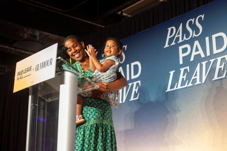 Storyteller and chef Karina Garcia holds her daughter Yohualli while sharing her story at the Paid Leave for All x Glamour evening celebration.