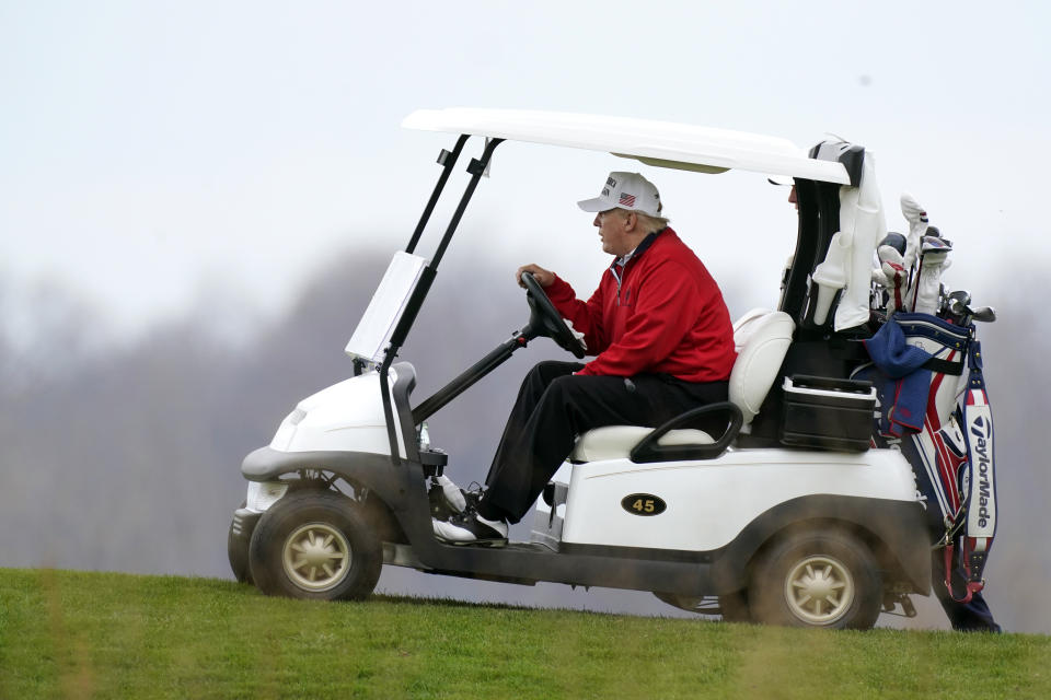 Trump drives a golf cart at Trump National Golf Club on Saturday. (Photo: AP Photo/Manuel Balce Ceneta)