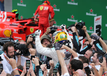 Formula One F1 - Brazilian Grand Prix - Autodromo Jose Carlos Pace, Interlagos, Sao Paulo, Brazil - November 11, 2018 Mercedes' Lewis Hamilton celebrates after winning the race REUTERS/Paulo Whitaker