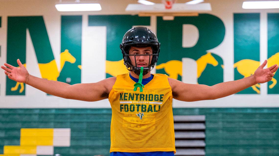 Kentridge quarterback Dorian Thomas talks over a play with his receivers during practice inside the school’s gym on Wednesday, Sept. 21, 2022, in Kent, Wash. Although Thomas quarterbacks the Chargers, we has committed to Oregon State where he will play tight end.