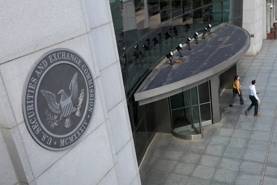 People exit the headquarters of the U.S. Securities and Exchange Commission (SEC) in Washington, D.C., U.S., May 12, 2021. Picture taken May 12, 2021. REUTERS/Andrew Kelly