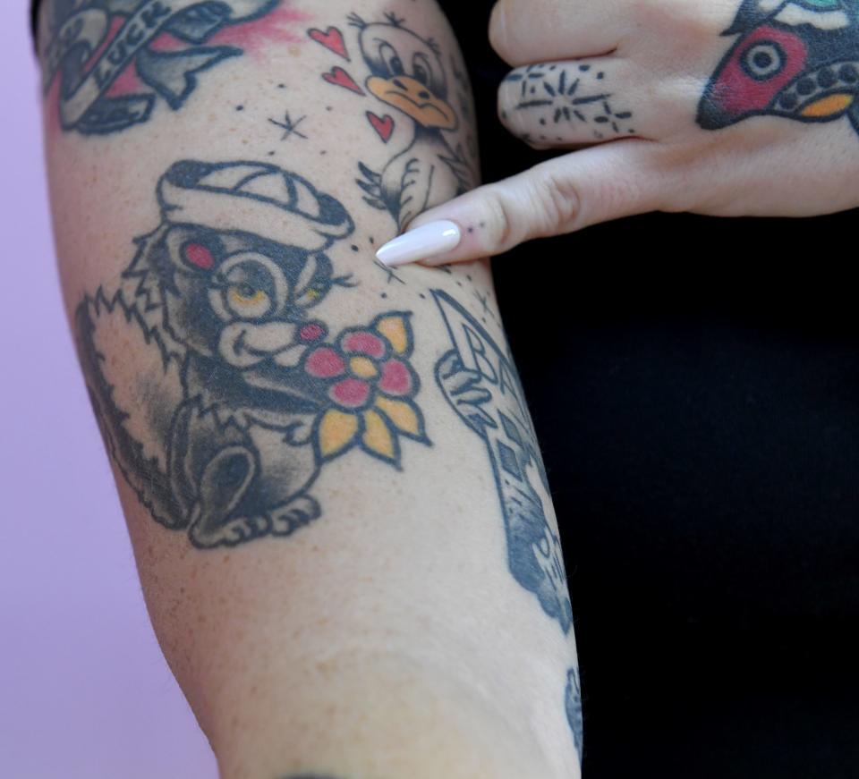 Peach, owner and head tattooer of Crybaby Tattoo, shows her tattoos at 225 E Main Street in Salisbury, Maryland.