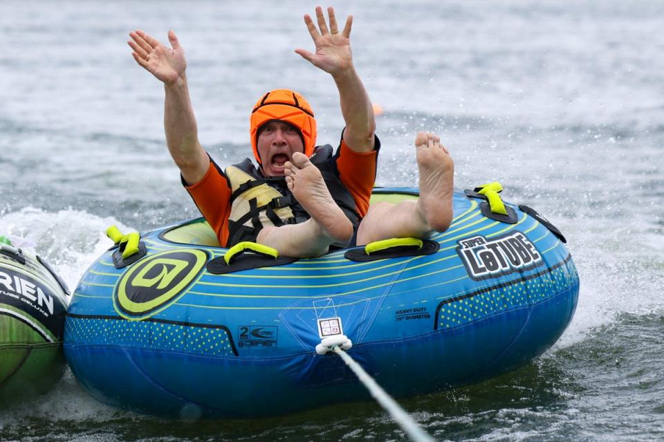 Ed Davey rides an inflatable doughnut (REUTERS)