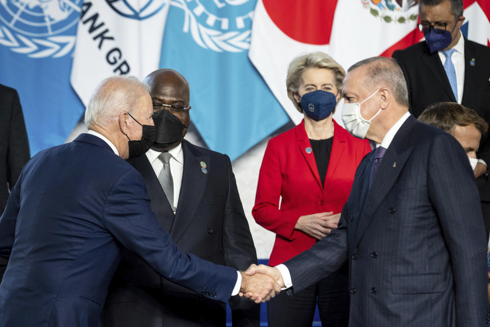 U.S. President Joe Biden, left, shakes hands with Turkish President Recep Tayyip Erdogan ahead of the opening session of the G20 summit at the La Nuvola conference center, in Rome, Saturday, Oct. 30, 2021. The two-day Group of 20 summit is the first in-person gathering of leaders of the world's biggest economies since the COVID-19 pandemic started. (Erin Schaff/Pool Photo via AP)