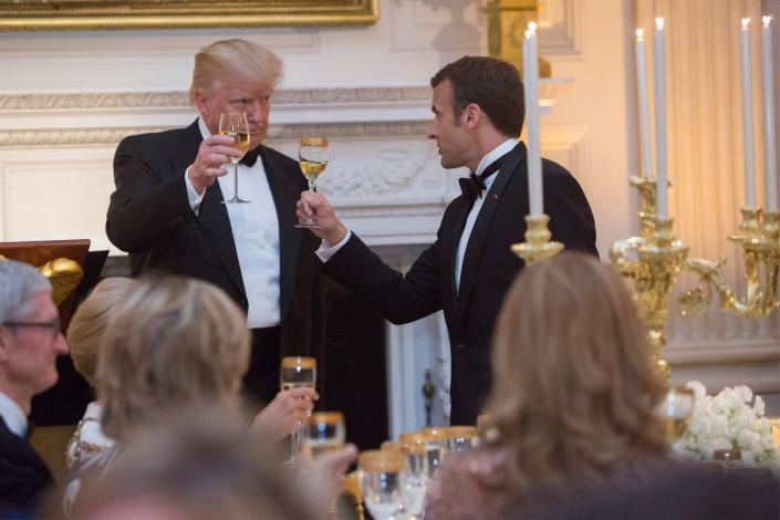 <p>During the event, both men shared a toast over what looks like a glass of white wine. Gold-adorned vessels complimented the ornate candlestick holders located on the head table. </p>