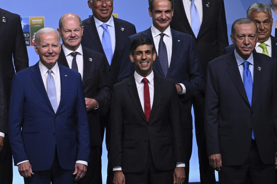 Participants of the NATO Summit including from left, U.S. President Joe Biden, Britain's Prime Minister Rishi Sunak and Turkey's President Recep Tayyip Erdogan, from left, pose for an official family photo in Vilnius, Lithuania, Tuesday, July 11, 2023. Turkish President Recep Tayyip Erdogan's abrupt approval of Sweden's NATO bid came after a year of objections to Stockholm to joining the defense alliance. (Andrew Caballero-Reynolds/Pool Photo via AP)