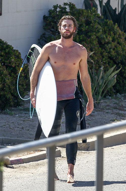 Liam Hemsworth bares all before a day in the surf