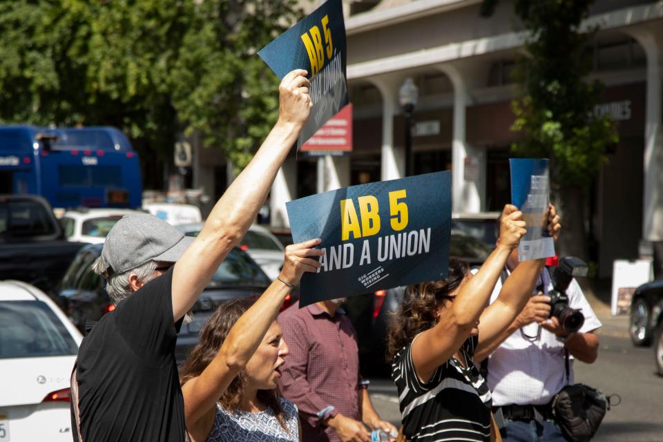 Lyft and Uber drivers rally in support of AB 5 on Wednesday, Aug. 28, 2019, in  Sacramento, Calif.