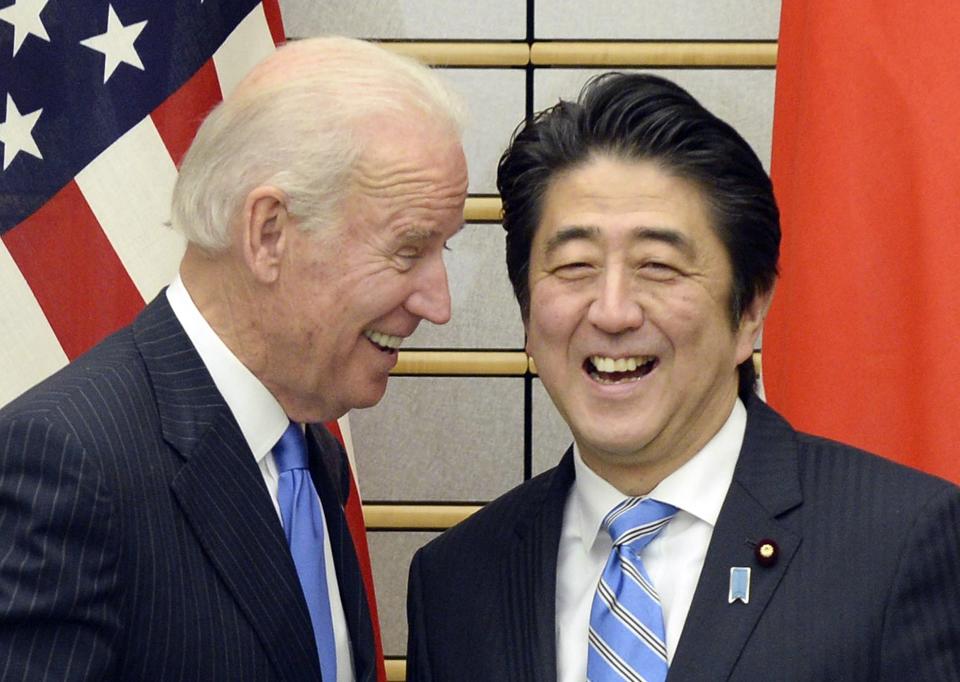 U.S. Vice President Joe Biden exchange smiles with Japanese Prime Minister Shinzo Abe at the start of their meeting at Abe's official residence in Tokyo