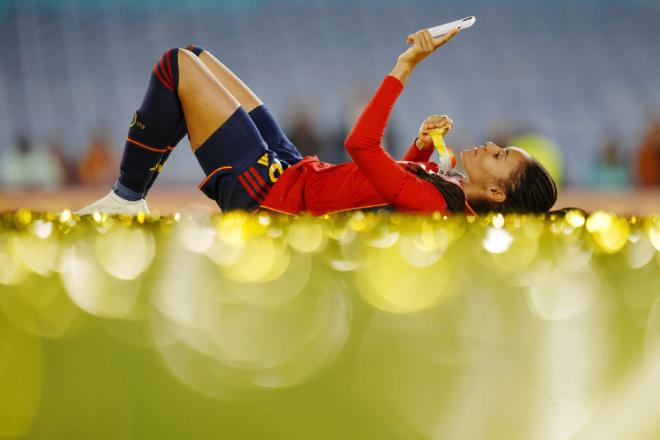 Spain's Salma Paralluelo lies on the ground with her medal at the end of the Women's World Cup soccer final between Spain and England at Stadium Australia in Sydney, Australia, Sunday, Aug. 20, 2023. Spain won 1-0. (AP Photo/Abbie Parr)