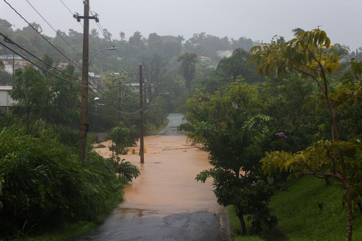 A road is flooded by the rains of Hurricane Fiona in Cayey, Puerto Rico, Sunday, September 18, 2022.