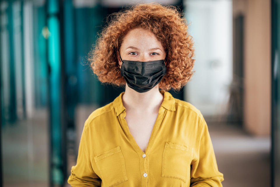 Many Canadians are opting to continue to wear face coverings even as mask restrictions lift across the country. (Image via Getty Images)