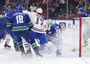 Vancouver Canucks goalie Casey DeSmith (29) stops Montreal Canadiens' Josh Anderson (17) during the first period of an NHL hockey game Thursday, March 21, 2024, in Vancouver, British Columbia. (Darryl Dyck/The Canadian Press via AP)