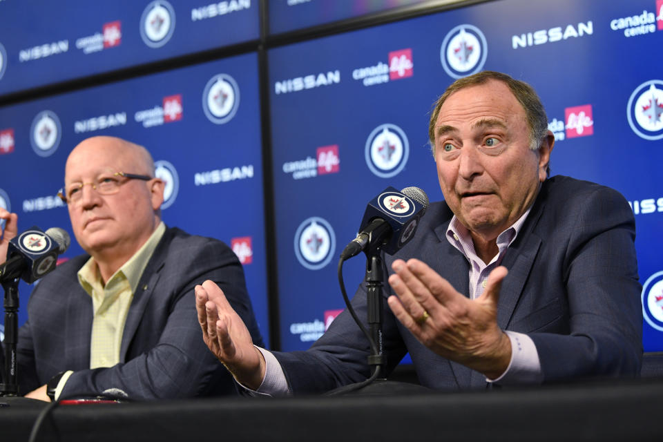 NHL Commissioner Gary Bettman, right, and Deputy Commissioner Bill Daly speak to reporters before an NHL hockey game between the St. Louis Blues and the Winnipeg Jets on Tuesday, Feb. 27, 2024, in Winnipeg, Manitoba. (Fred Greenslade/The Canadian Press via AP)