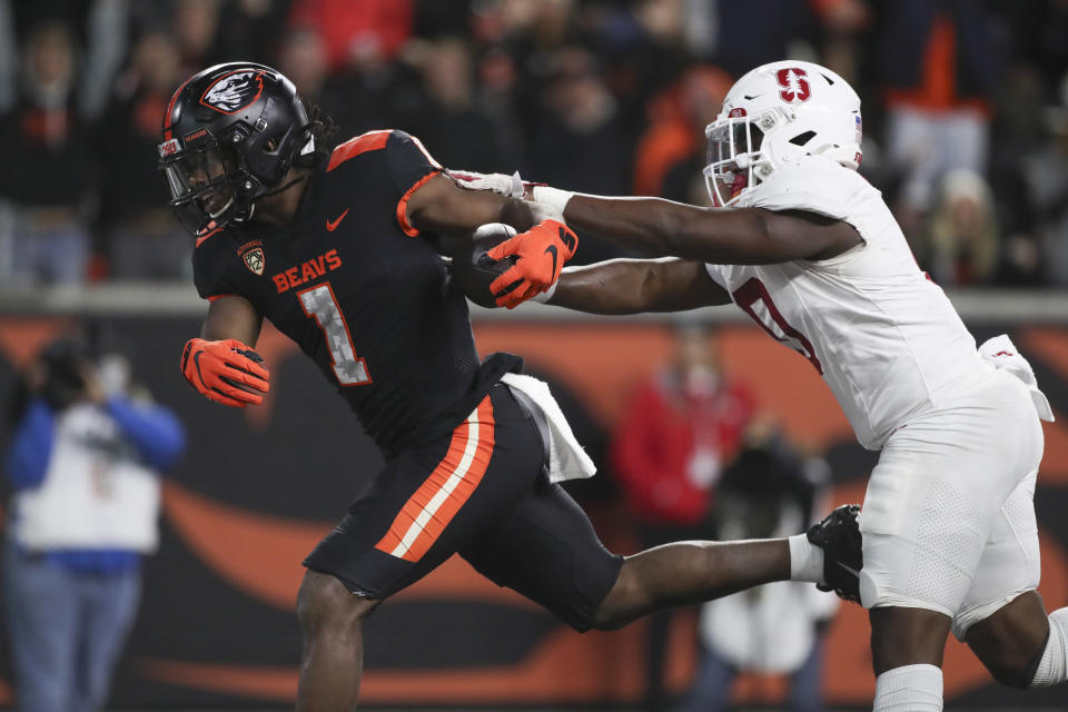 Oregon State running back Deshaun Fenwick (1) runs into the end zone to score a touchdown ahead of Stanford linebacker Gaethan Bernadel (0) during the second half of an NCAA college football game Saturday, Nov. 11, 2023, in Corvallis, Ore. Oregon State won 62-17. (AP Photo/Amanda Loman)