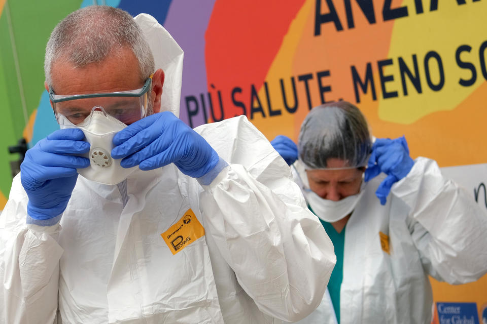 Volunteer doctors prepare to administer swabs for COVID-19 at a nursing home in Santa Marinella, near Rome, Tuesday, April 21, 2020. Italian Premier Giuseppe Conte on Tuesday confirmed that Italy can start reopening on May 4, but he doused any hopes of a total loosening of some of the strictest lockdown measures in a western democracy. (Mauro Scrobogna/LaPresse via AP)