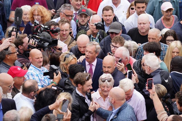 Leader of Reform UK Nigel Farage surrounded by crowds as he departs the launch of his General Election campaign in Clacton-on-Sea, Essex 