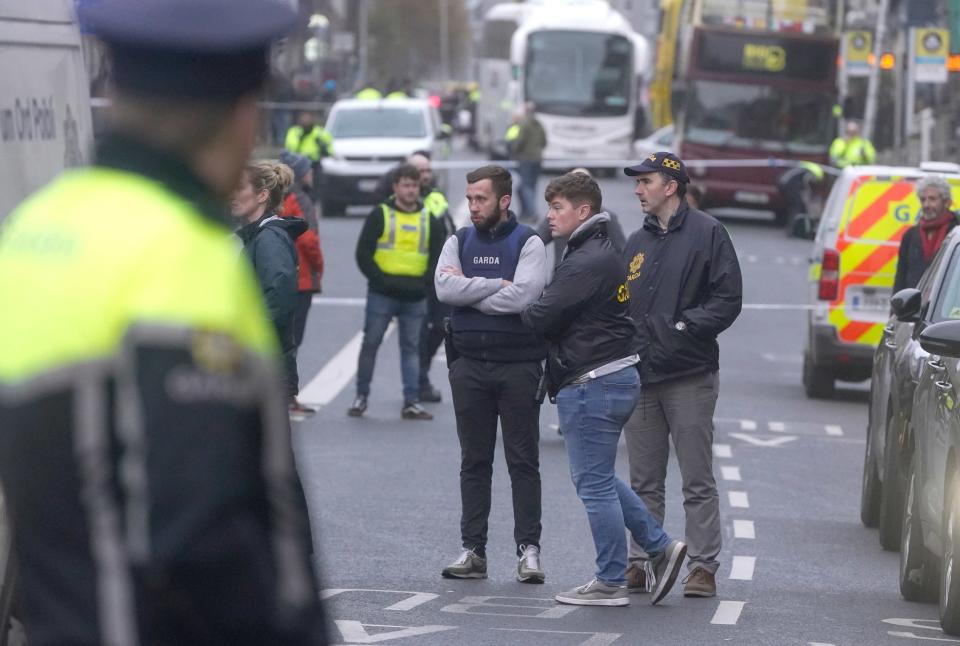 People gathering at the scene in Dublin city centre after five people were injured (PA)