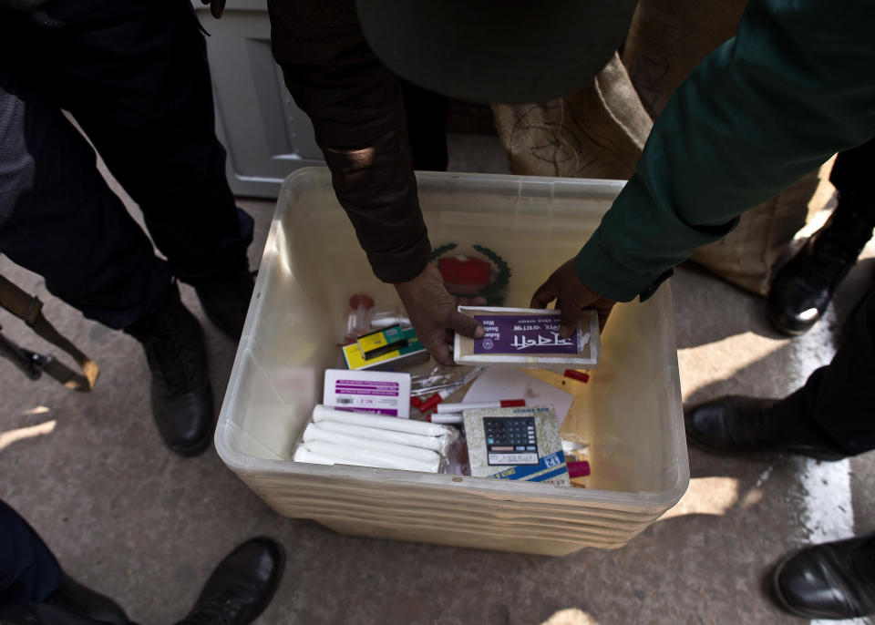 Bangladeshi polling officials check the voting material at a distribution center before being transported to polling stations on the eve of the general elections in Dhaka, Bangladesh, Saturday, Dec. 29, 2018. As Bangladeshis get set for Sunday's parliamentary elections, there are fears that violence and intimidation could keep many away from the polls, including two opposition candidates who said police had barricaded them inside their homes. (AP Photo/Anupam Nath)