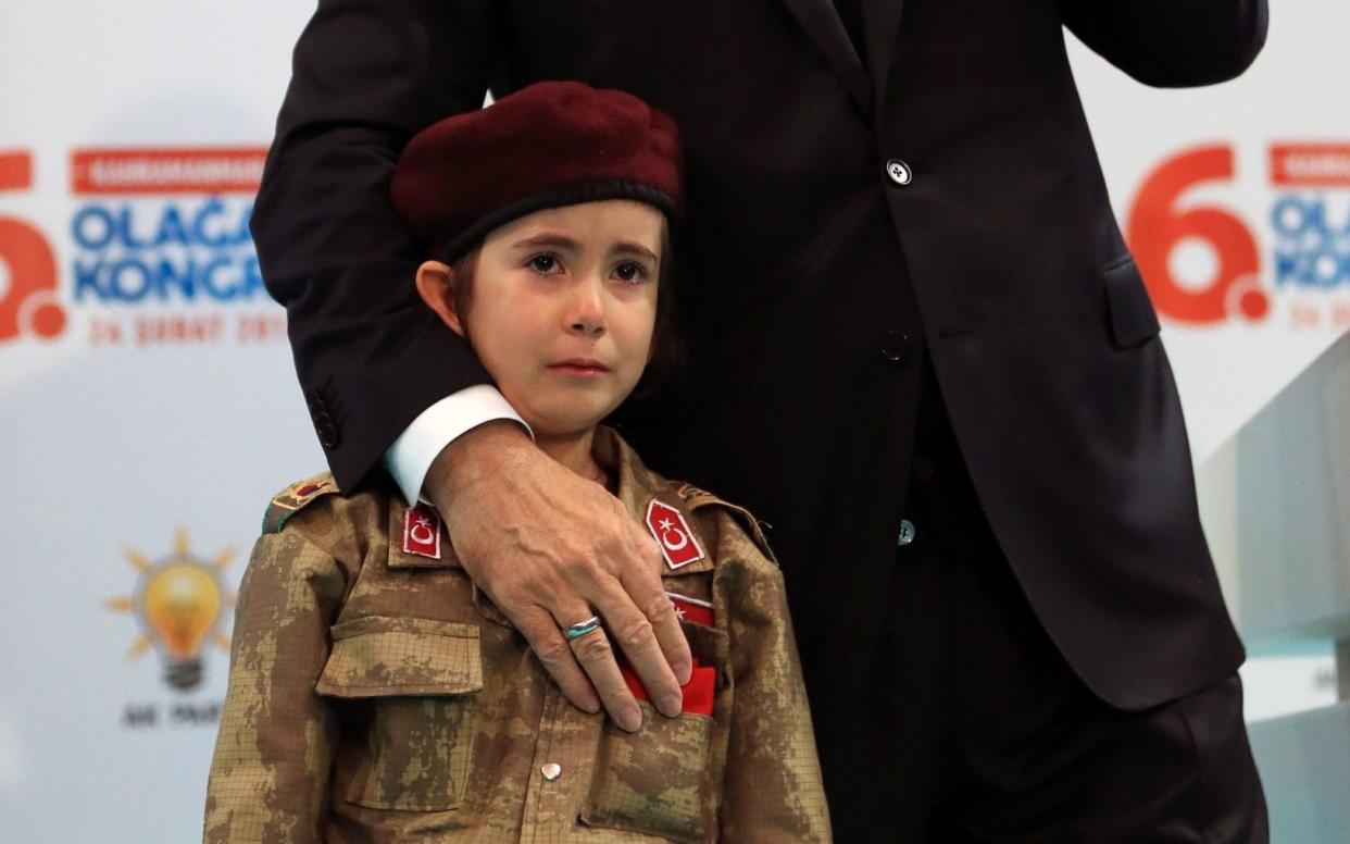 Recep Tayyip Erdogan told a tearful young girl in military uniform that the country would honour her if she became a martyr - Anadolu