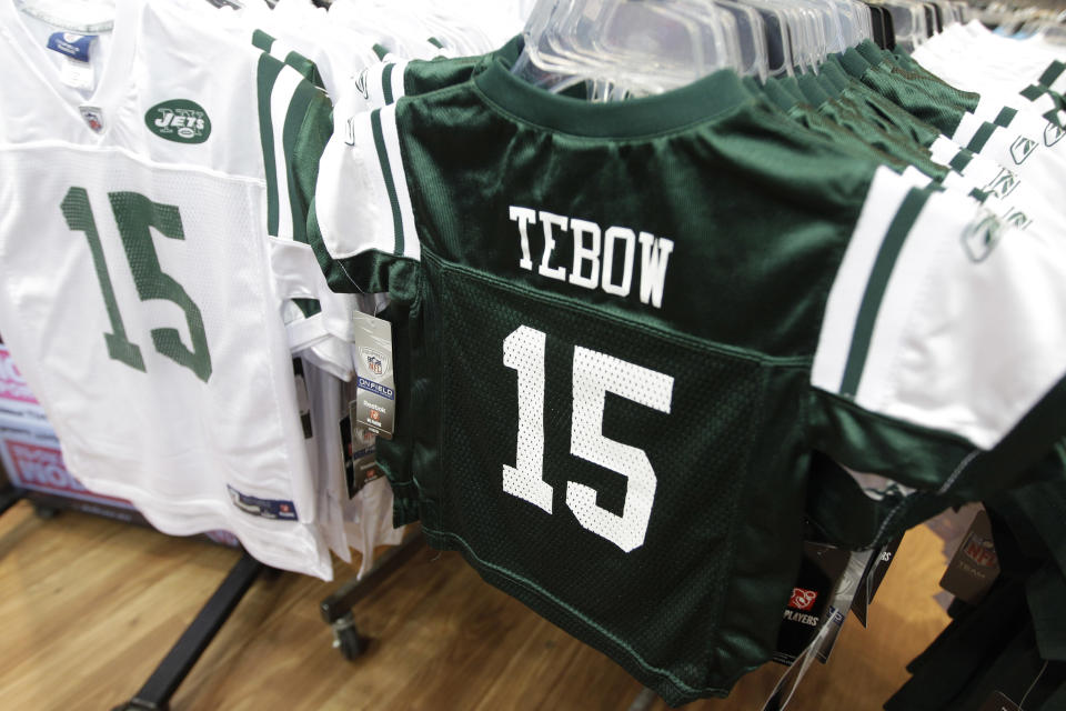 FILE - In this March 26, 2012, file photo, Reebok brand New York Jets football jerseys with the name and number of their new quarterback Tim Tebow hang on display at a Modell's store in New York. Nike Inc. claims in a lawsuit on Wednesday, March 28, 2012, in U.S. District Court that Reebok International Ltd. has used Tebow's name on Jets-related apparel without permission since it was announced last week that Tebow was traded from the Denver Broncos to New York. The Tebow trade occurred just before Nike replaces Reebok on Sunday as the supplier of NFL team uniforms. (AP Photo/Mary Altaffer, File)