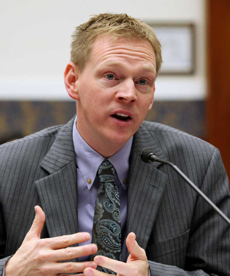 FILE-- In this Oct. 2013 photo, Iowa Workers' Compensation Commissioner Chris Godfrey speaks in Des Moines, Iowa. Godfrey, a Democrat, sued Branstad for discrimination in 2012, shortly after he was elected to the first of his two most recent terms as governor. Jury selection began Monday, June 3, 2019, in what is expected to be a monthlong civil trial over allegations that former Iowa Gov. Terry Branstad pressured Godfrey to quit because he was gay, a case Branstad's attorney predicts will escalate into an "unhinged attack on the Republican Party." (The Des Moines Register via AP)