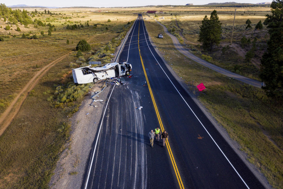 The remains of a bus that crashed while carrying Chinese-speaking tourists lie along State Route 12 near Bryce Canyon National Park, Friday, Sept. 20, 2019, in Utah, as authorities continue to investigate. (Spenser Heaps/The Deseret News via AP)