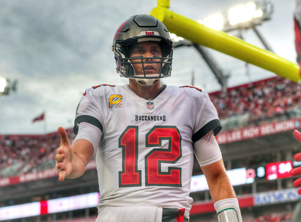 Tampa Bay Buccaneers Quarterback Tom Brady (12) reaches out to congratulate Mike Evans after Evans caught Brady's 600th career touchdown pass during the regular season game between the Chicago Bears and the Tampa Bay Buccaneers on October 24, 2021 at Raymond James Stadium in Tampa, Florida. (Photo by Cliff Welch/Icon Sportswire via Getty Images)