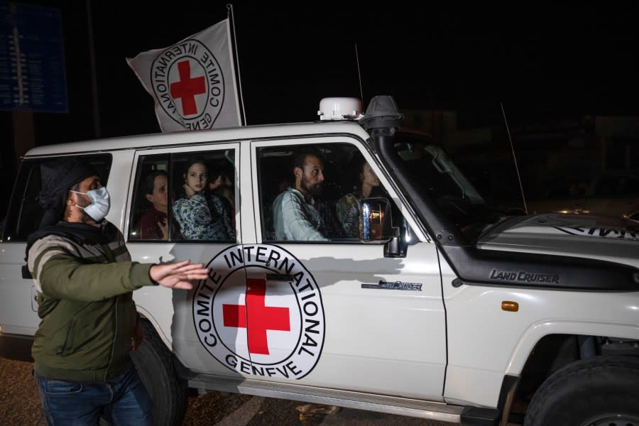 A Red Cross vehicle carrying Israeli hostages drives by at the Gaza Strip crossing into Egypt in Rafah on Saturday, Nov. 25, 2023. (AP Photo/Fatima Shbair)