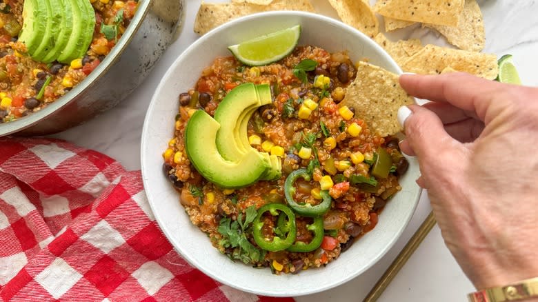 hand dipping chip in dish