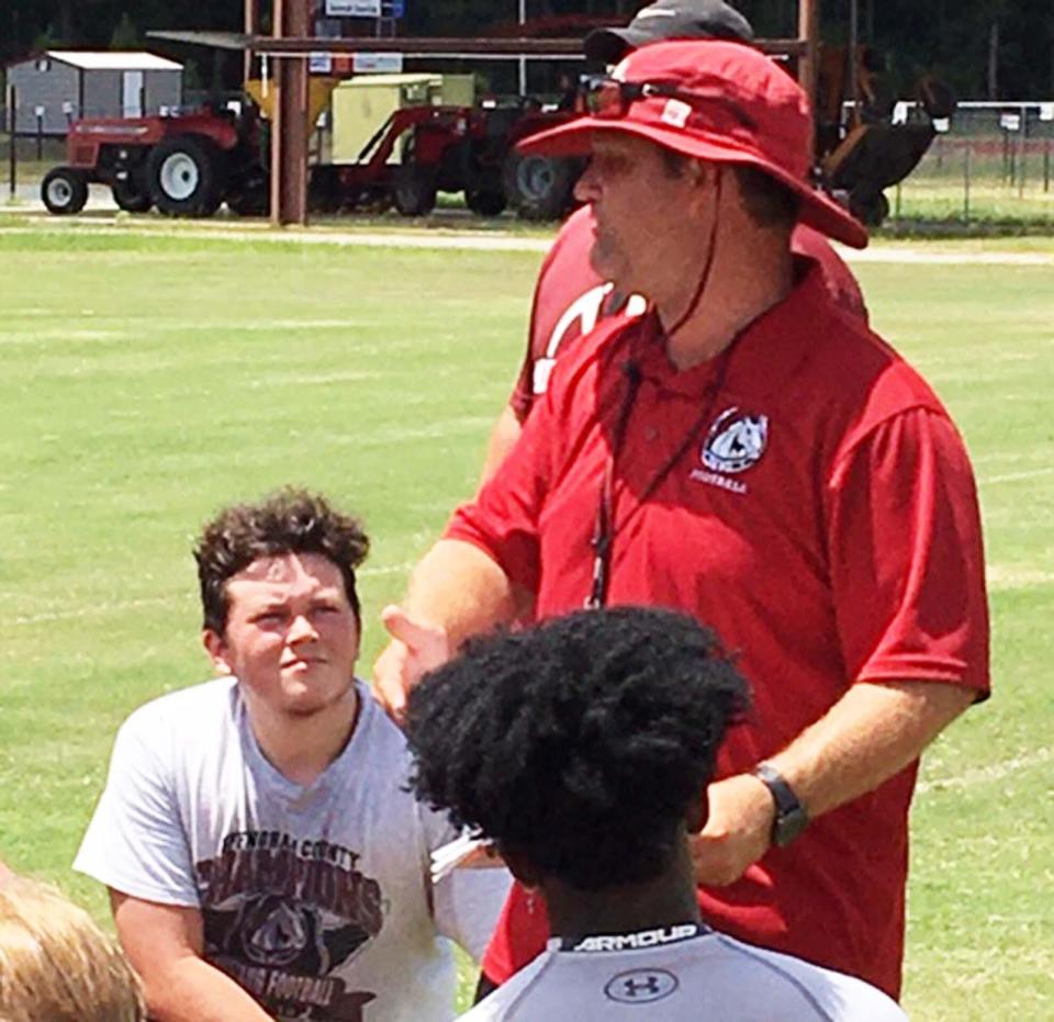 South Effingham football coach Nathan Clark talks to his team after a practice in a past season.