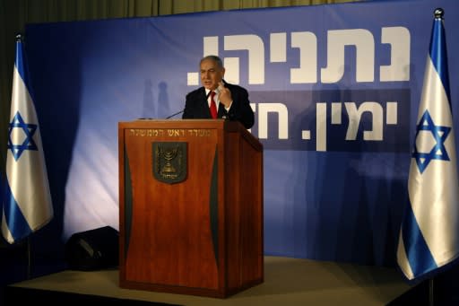 "Netanyahu Strong Right" reads the campaign banner behind the Israeli prime minister, who faced a serious challenge from a centrist alliance led by the former armed forces chief in an April 9 election even before the attorney general's announcement