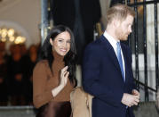 FILE - In this Tuesday, Jan. 7, 2020 file photo, Britain's Prince Harry and Meghan, Duchess of Sussex smile as they leave Canada House, in London. Prince Harry and his wife Meghan 'stepping back' as senior UK royals, will work to become financially independent, they announced Wednesday, Jan. 8, 2020.(Daniel Leal-Olivas/Pool Photo via AP, file)