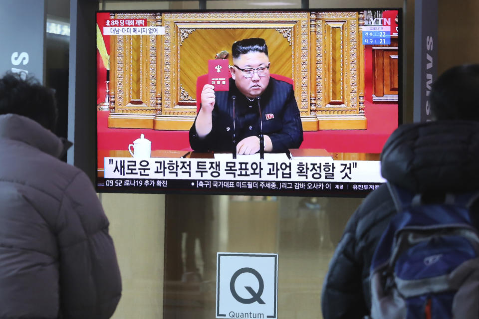 People watch a TV screen showing North Korean leader Kim Jong Un during a ruling party congress, at the Seoul Railway Station in Seoul, South Korea, Wednesday, Jan. 6, 2021. Kim opened his country's first ruling party congress in five years with an admission of policy failures and a vow to set new developmental goals, state media reported Wednesday. The sign reads "New goals and tasks to be confirmed." (AP Photo/Ahn Young-joon)