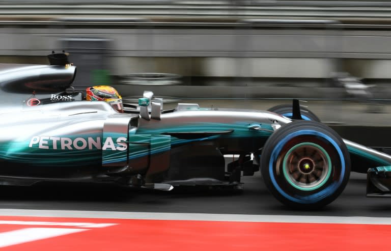 Lewis Hamilton drives through pit lane during a practice session ahead of the Formula One Chinese Grand Prix in Shanghai, where he is seeking his first win of the season