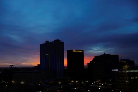 The sun rises behind a Wells Fargo building in El Paso, Texas