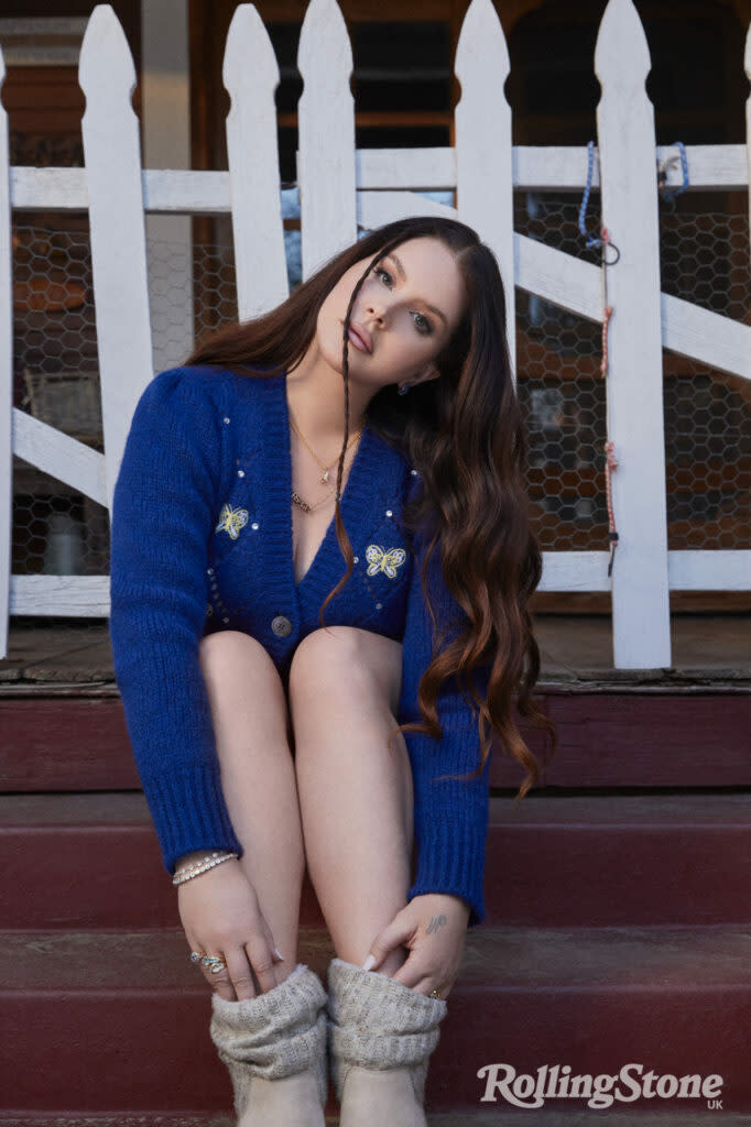 Lana wears knitwear by Alessandra Rich at MyTheresa, denim shorts by Ganni at Selfridges, necklace and rings by Pawnshop London, vintage Versace necklace at Susan Caplan, earrings by Swarovski, bracelets and boots, Lana’s own. (Picture: Chuck Grant. Styling: Joseph Kocharian)