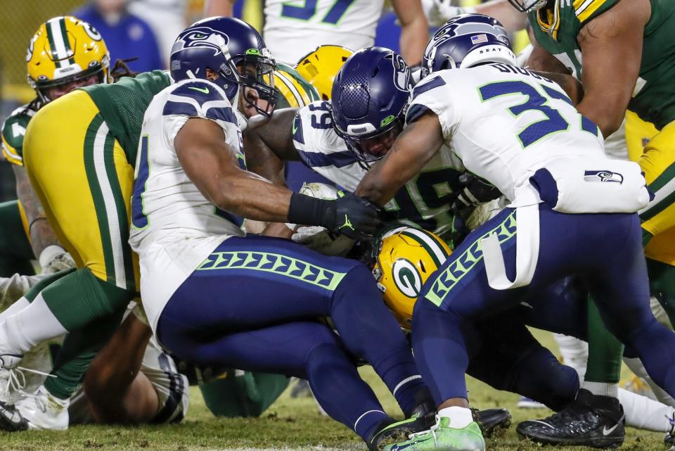 Green Bay Packers' Aaron Jones runs for a touchdown during the first half of an NFL divisional playoff football game against the Seattle Seahawks Sunday, Jan. 12, 2020, in Green Bay, Wis. (AP Photo/Matt Ludtke)