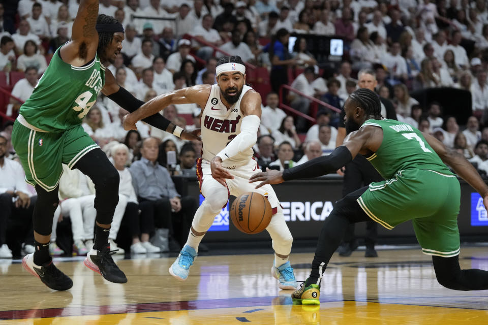 Boston Celtics center Robert Williams III (44) and guard Jaylen Brown (7) defend Miami Heat guard Gabe Vincent (2) during the first half of Game 4 during the NBA basketball playoffs Eastern Conference finals, Tuesday, May 23, 2023, in Miami. (AP Photo/Wilfredo Lee)