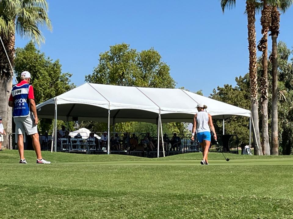 Fans watch from a tented viewing area near the 18th green at the Indian Wells Golf Resort during the final round of the Epson Tour Championship