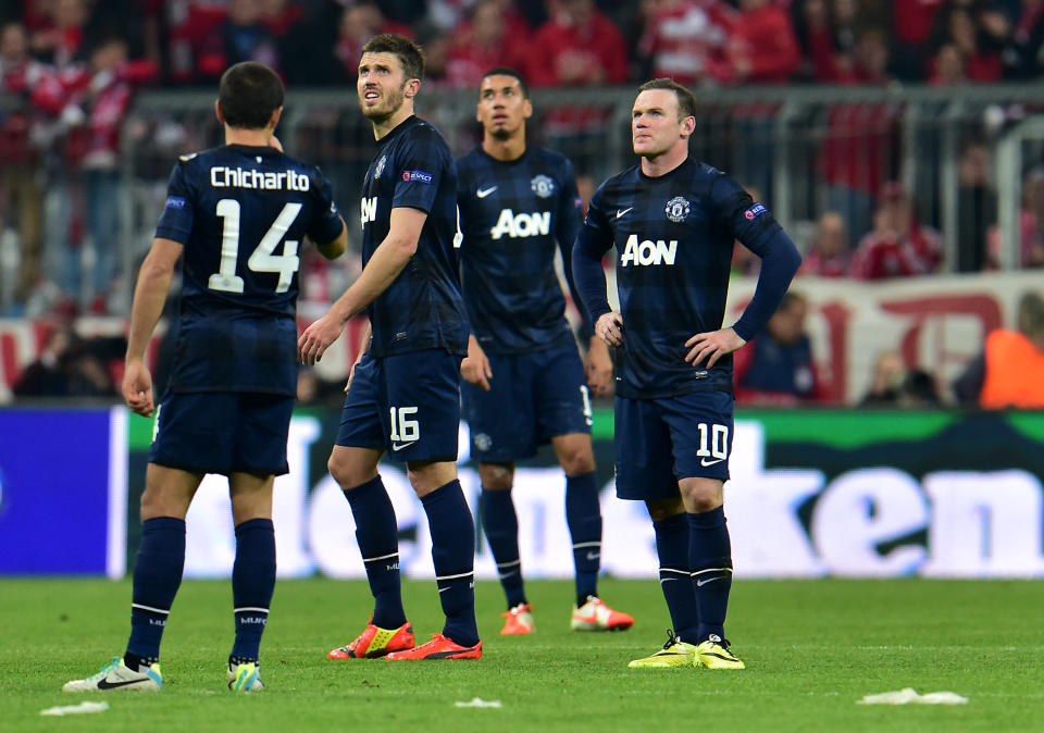 Manchester United's Wayne Rooney, right, looks on after Munich scored the third goal during the Champions League quarterfinal second leg soccer match between Bayern Munich and Manchester United in the Allianz Arena in Munich, Germany, Wednesday, April 9, 2014. (AP Photo/Kerstin Joensson)