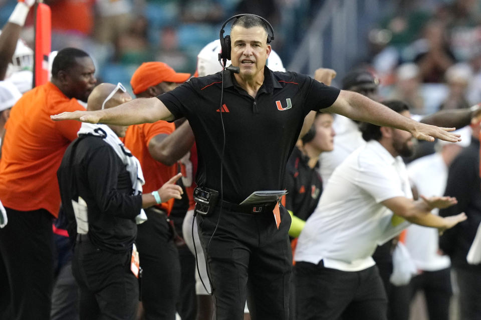 Miami head coach Mario Cristobal calls a play during the second half of an NCAA college football game against Virginia, Saturday, Oct. 28, 2023, in Miami Gardens, Fla. (AP Photo/Lynne Sladky)