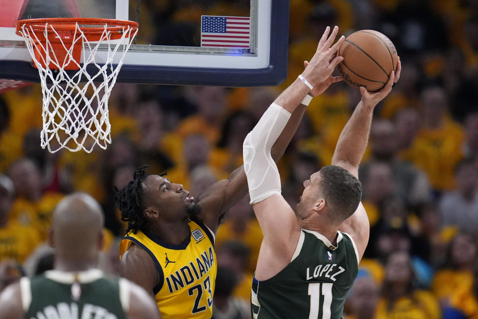 Indiana Pacers forward Aaron Nesmith (23) blocks a shot by Milwaukee Bucks center Brook Lopez during the first half in Game 6 in an NBA basketball first-round playoff series, Thursday, May 2, 2024, in Indianapolis. (AP Photo/Michael Conroy)