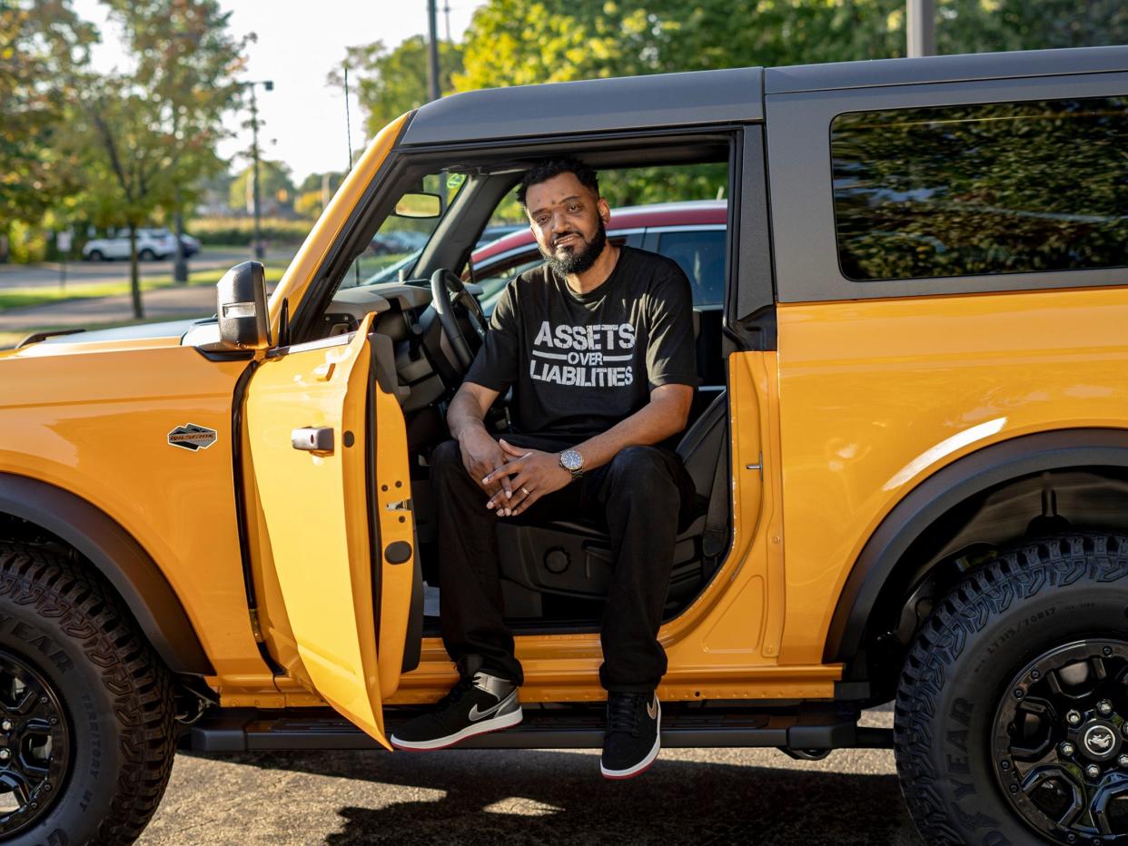 Lavell Riddle sits in the driver seat of his yellow jeep with the door opened