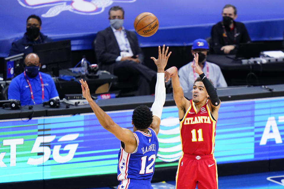 Atlanta Hawks' Trae Young, right, goes up for a shot against Philadelphia 76ers' Tobias Harris during the second half of Game 5 in a second-round NBA basketball playoff series, Wednesday, June 16, 2021, in Philadelphia. (AP Photo/Matt Slocum)