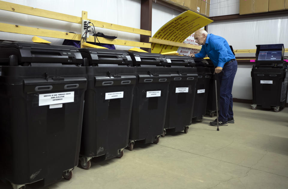 Bill Peifer, Democratic Party treasurer in Torrance County, inspects ballot-counting machines during a testing of election equipment in Estancia, N.M., Sept. 29, 2022. “Some of the people casting doubt I think honestly don’t trust the machines,” Peifer said. “And there are others who just want to make a mess.” (AP Photo/Andres Leighton)