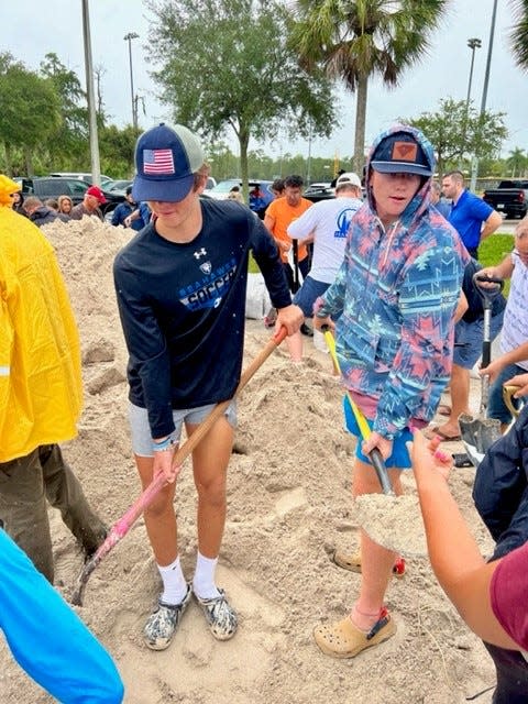 Miles Smith, Ramsey Huggins and their fellow Community School of Naples boys lacrosse  teammates helped bag more than four tons of sand Tuesday at North Collier Regional Park, 15000 Livingston Road, Naples. The bags were for anyone in the community who needs them, with a limit of 10 bags per person.