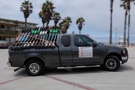 Scoot Scoop truck full of impounded scooters leaves the beach area after the two-wheeler devices were removed from private property in San Diego, California