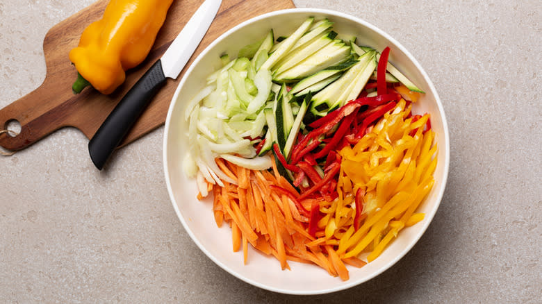 A bowl of julienned vegetables